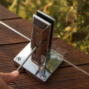 frameless glass pool fence spigot on a timber deck